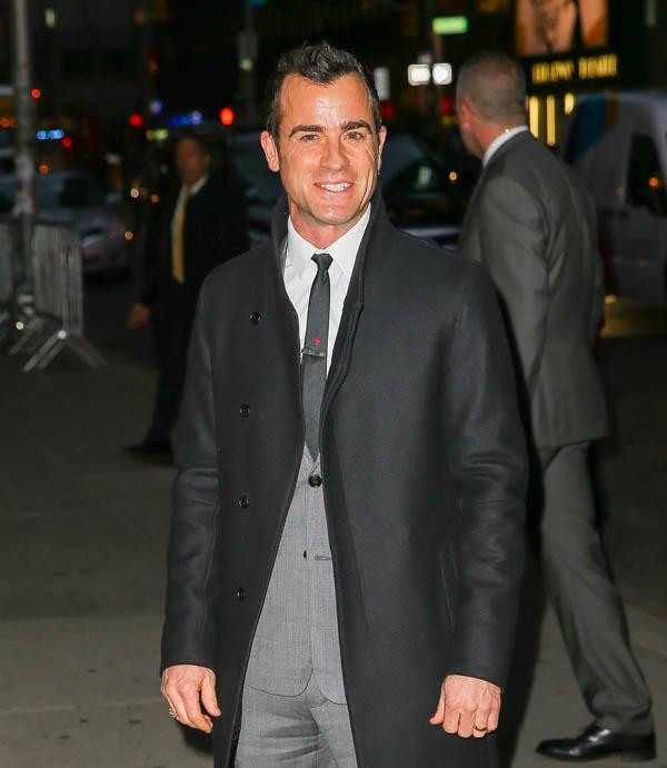 Justin Theroux flash a big smile while posing outside The Late Show with Stephen Colbert in New York City