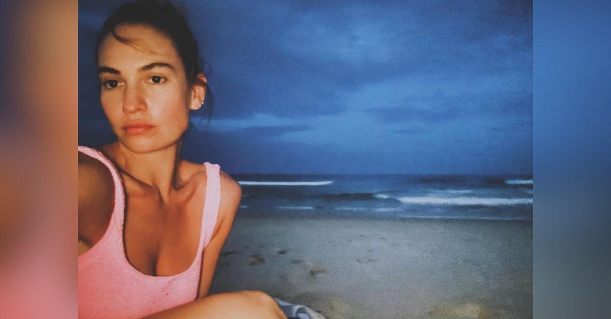 Image of Lily James enjoyed time on the beach at night.