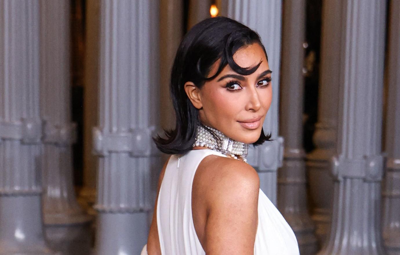 kim kardashian wearing princess diana cross necklace vulgar cleavage