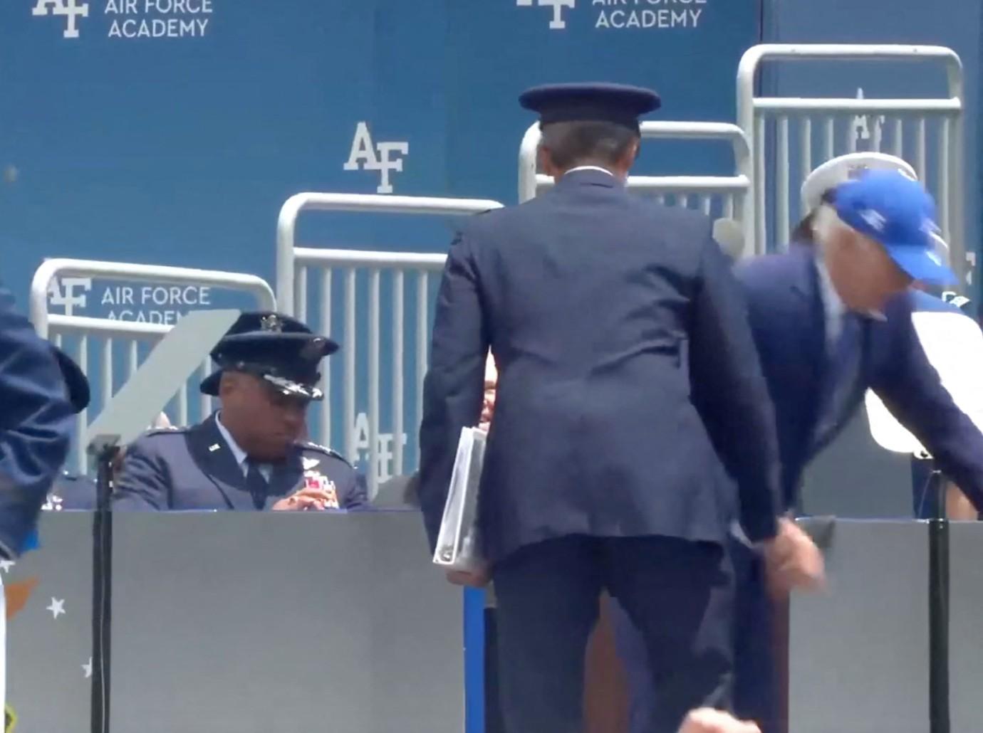 president joe biden bumps head helicopter doorframe after tripping onstage