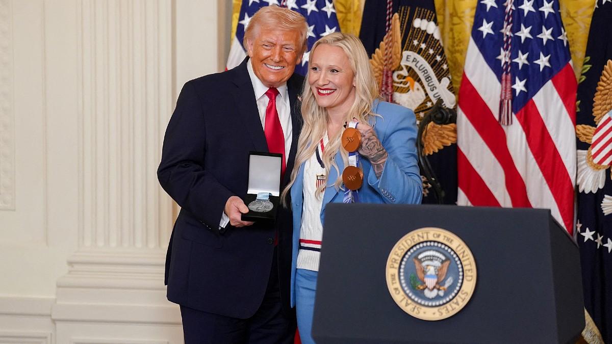 image of The Olympian posed alongside the president at the event. 