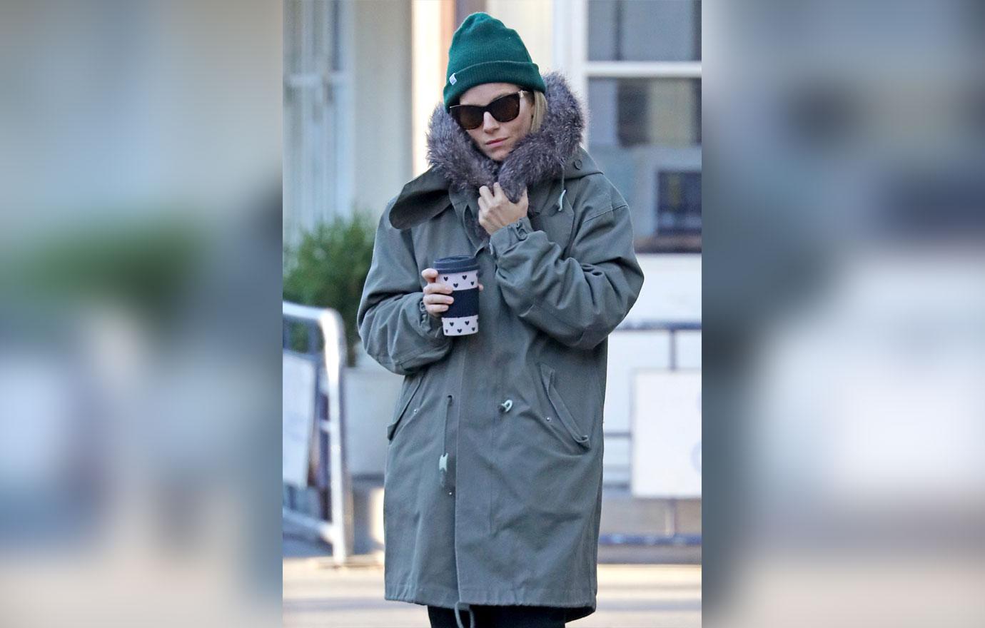 Sienna Miller keeps warm wearing a green Winter Jacket on her morning stroll, NYC