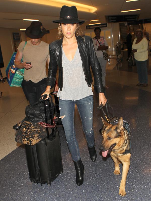 Nikki Reed and Ian Somerhalder wear matching hats as they arrive in Los Angeles with Reed&#039;s Service Dog