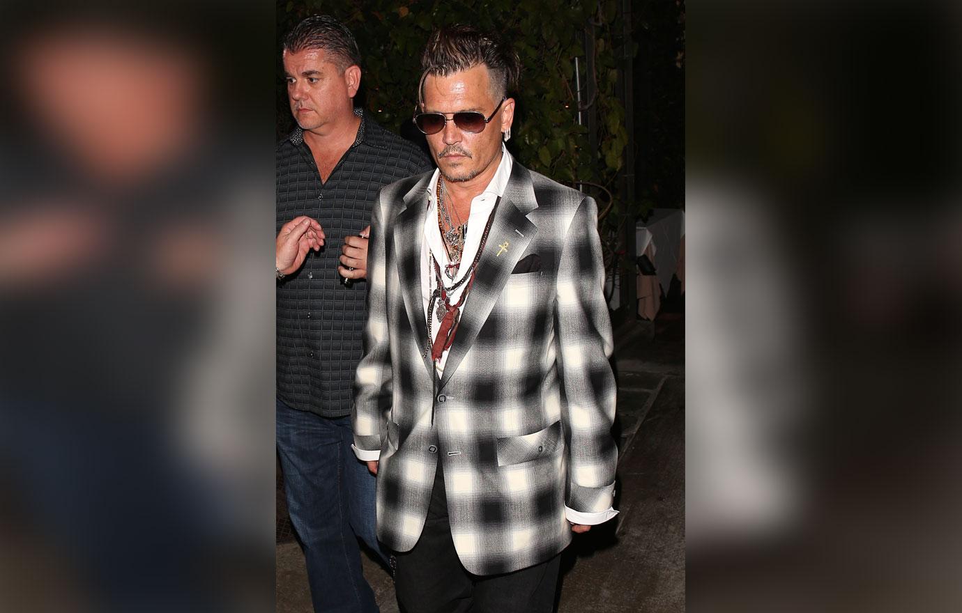 Johnny Depp looks somber after dinner at Ago Restaurant