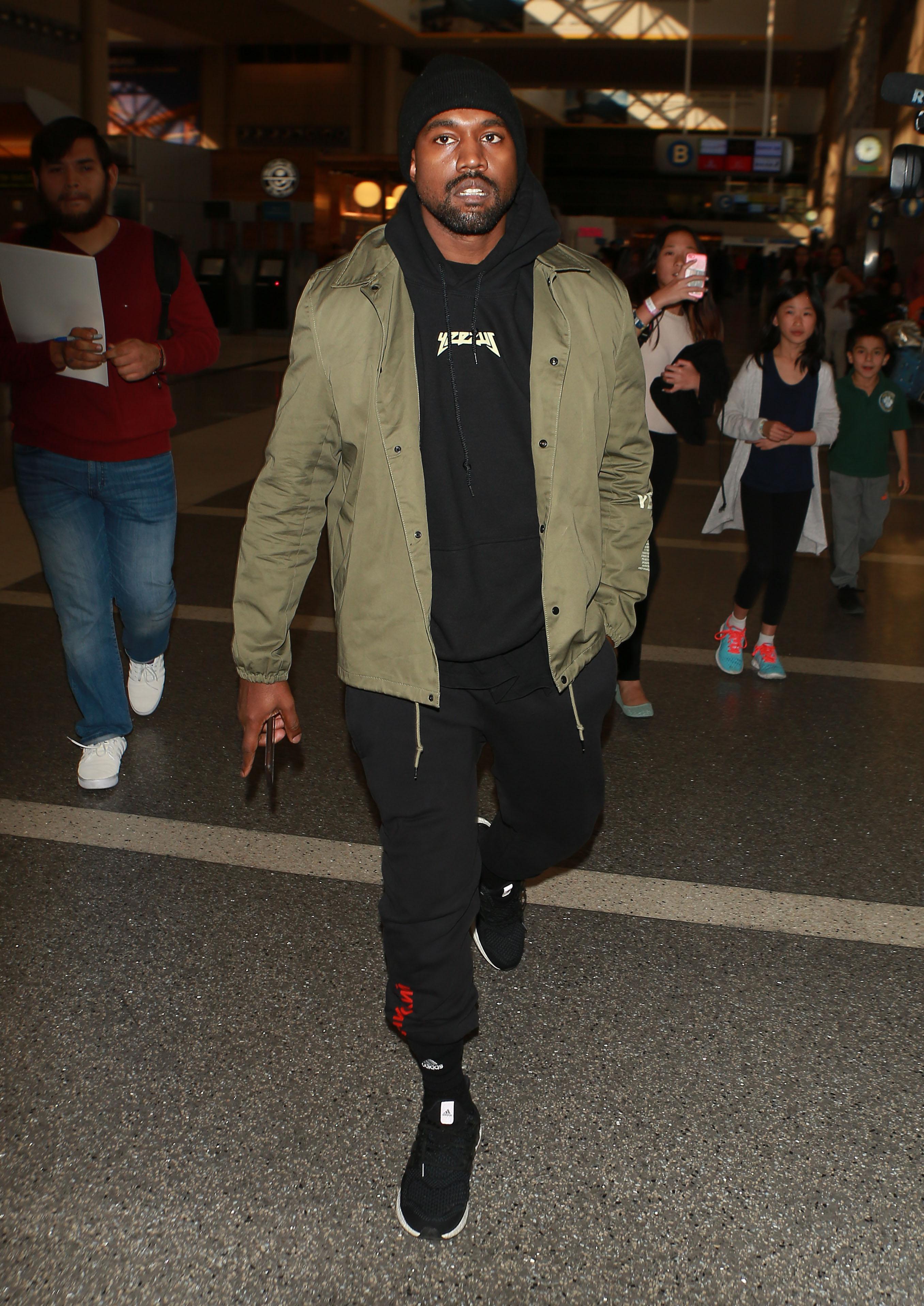 Kanye West departing on a flight at LAX airport ,in Los Angeles, CA