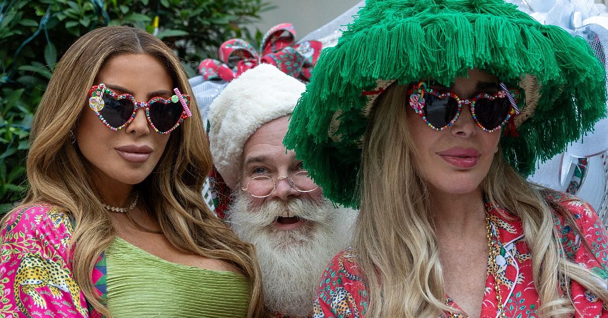 Larsa Pipper and Marysol Patton sit on Santa's lap.