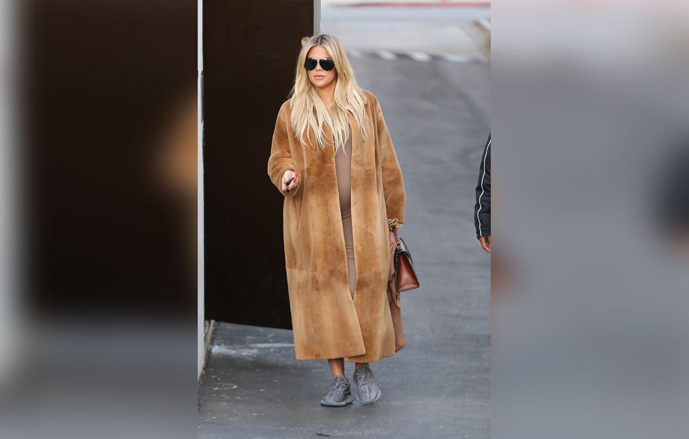 A pregnant Khloe Kardashian changes into Yeezys at the studio to be more comfortable