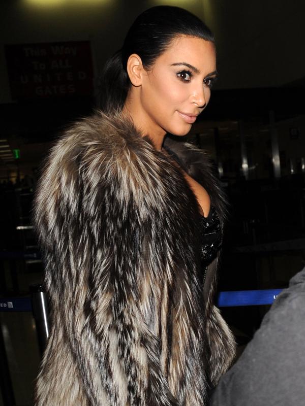 Kim Kardashian returns to LA in fur coat at LAX