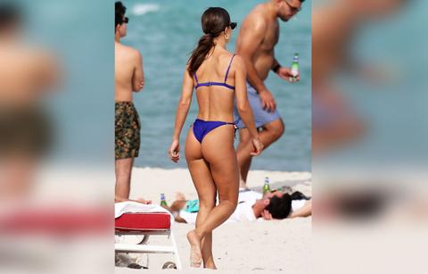camila coelho wears a blue bikini as she relaxes on the beach in miami
