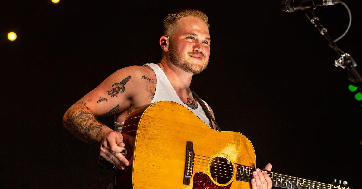 photo of Zach Bryan defended his song 'Bad News,' saying it is about how much he 'loves this country'