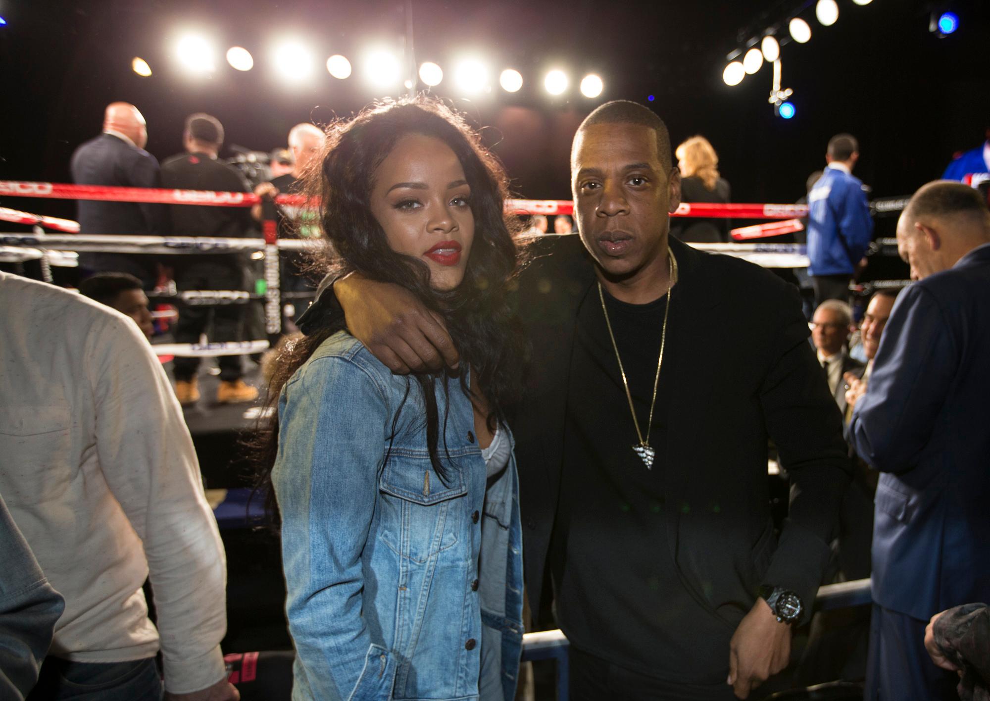 Jay Z and Rihanna pose together as they both sit ringside for a boxing card at Madison Square Garden