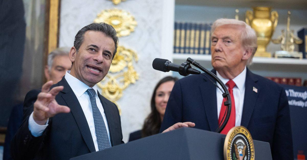 image of The president later sat down while others remained standing behind him.