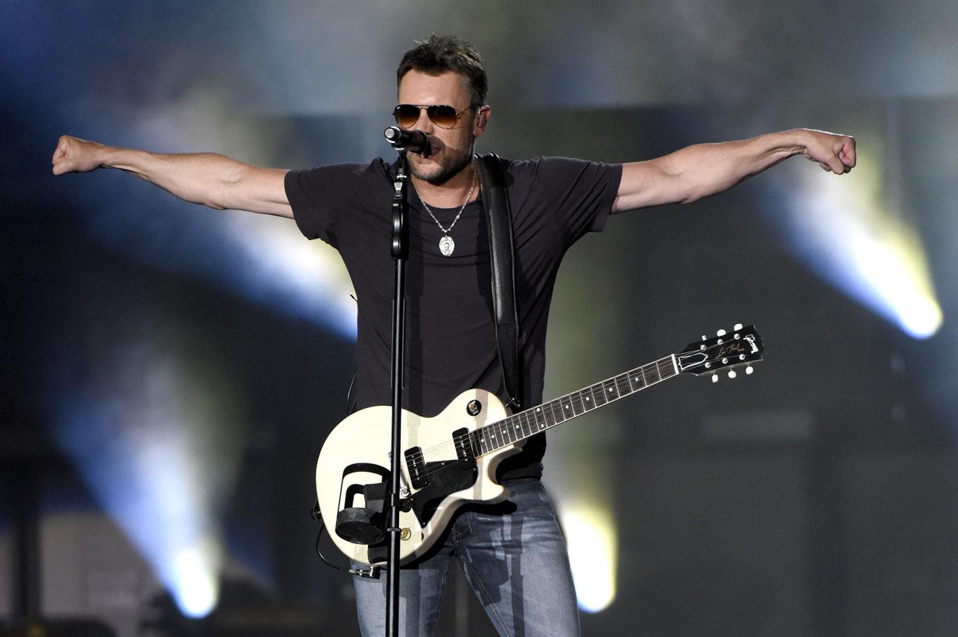 Eric church with his arms outstretched