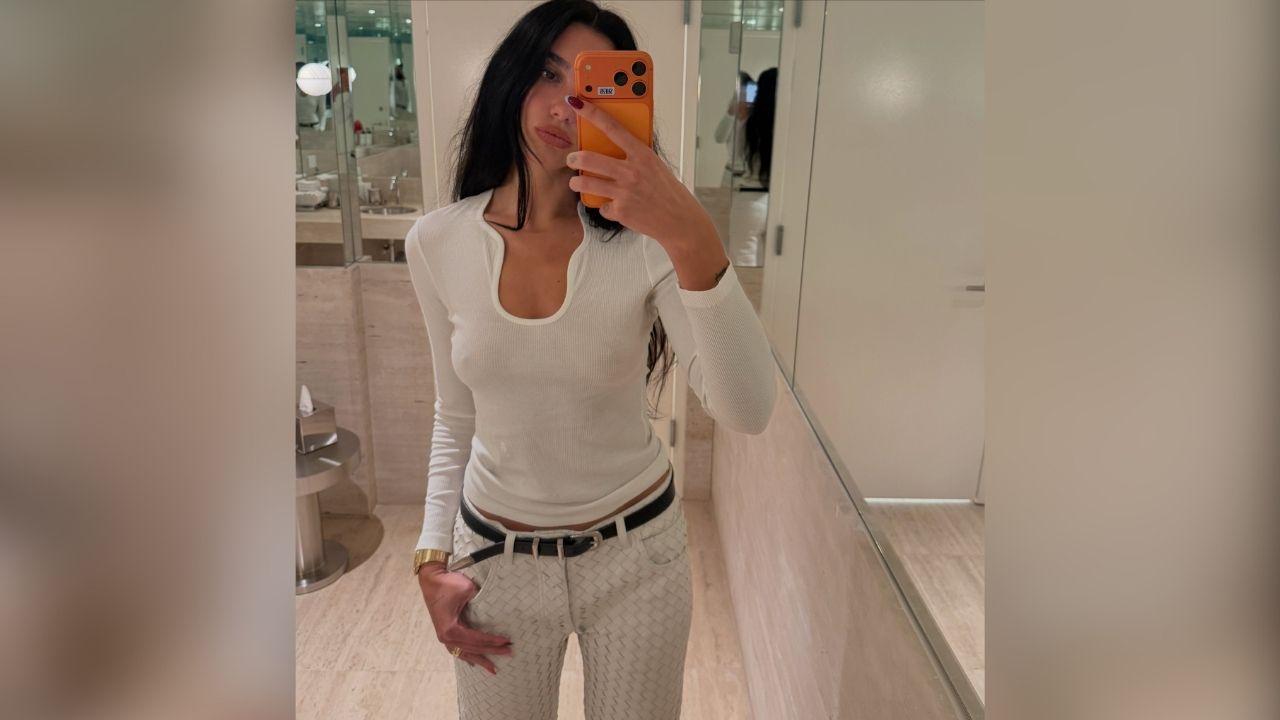 image of Dua Lipa recently shared photos of herself wearing a fitted white top with subtle sheer detailing and no bra underneath.