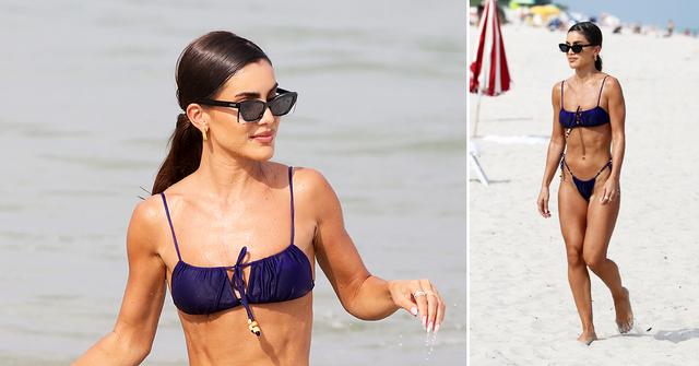 camila coelho wears a blue bikini as she relaxes on the beach in miami