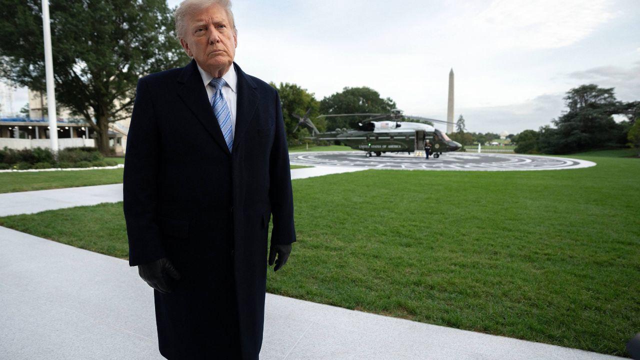image of Trump looking at gaggle of reporters near the White House helipad