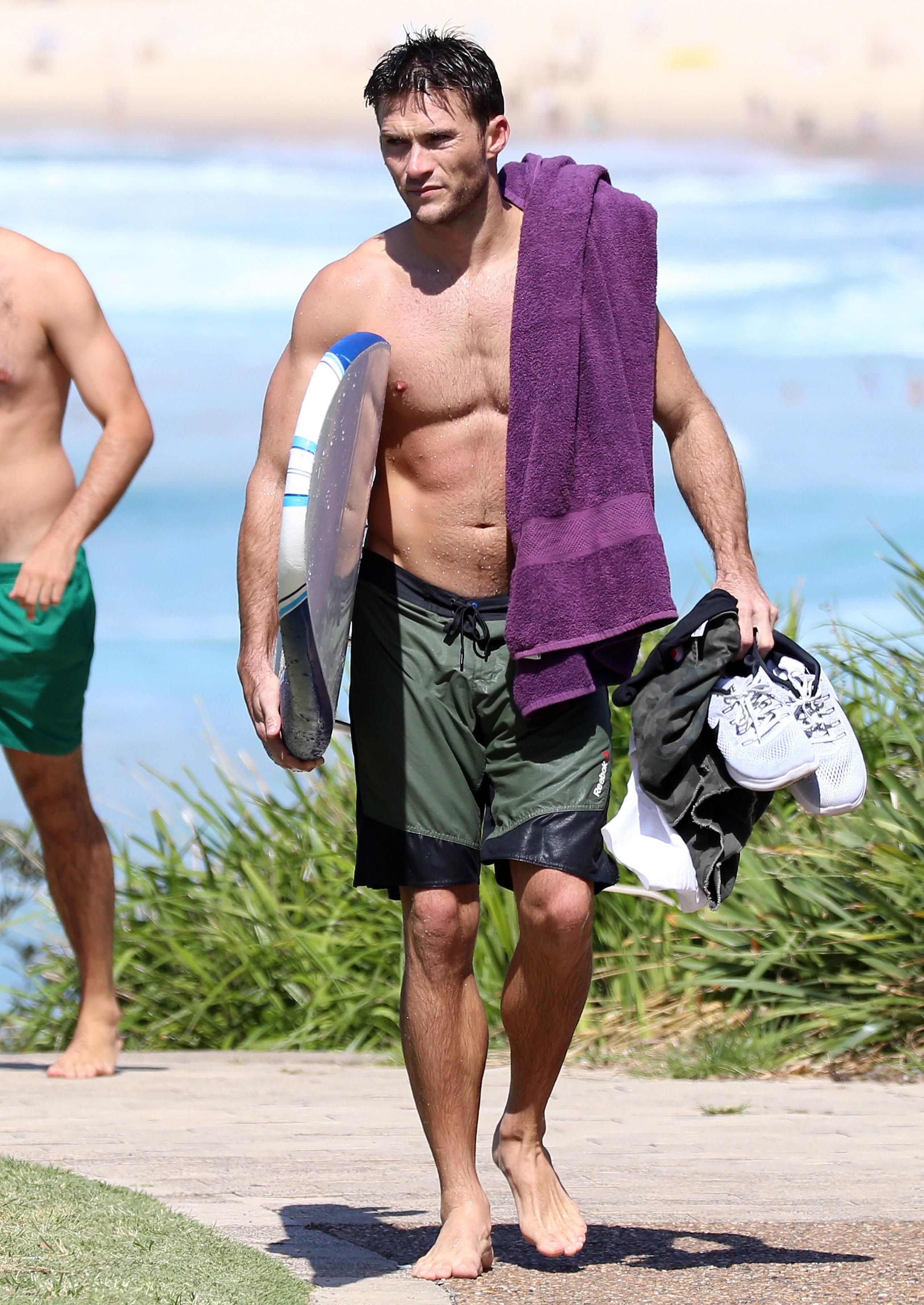 EXCLUSIVE: Scott Eastwood shows off his muscles while surfing at Bondi Beach.