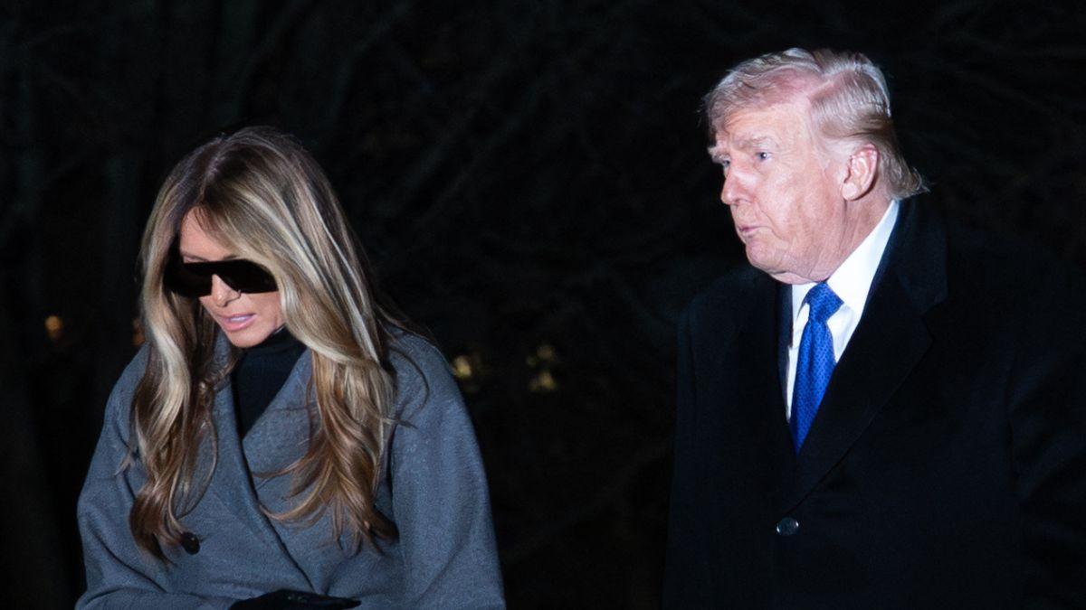 Image of Melania Trump shielded her eyes while returning to the White House in the dark.