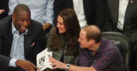 Prince William, Catherine Duchess of Cambridge and NBA Global Ambassador Dikembe Mutombo take in the game between the Cleveland Cavaliers against the Brooklyn Nets at the Barclays Center