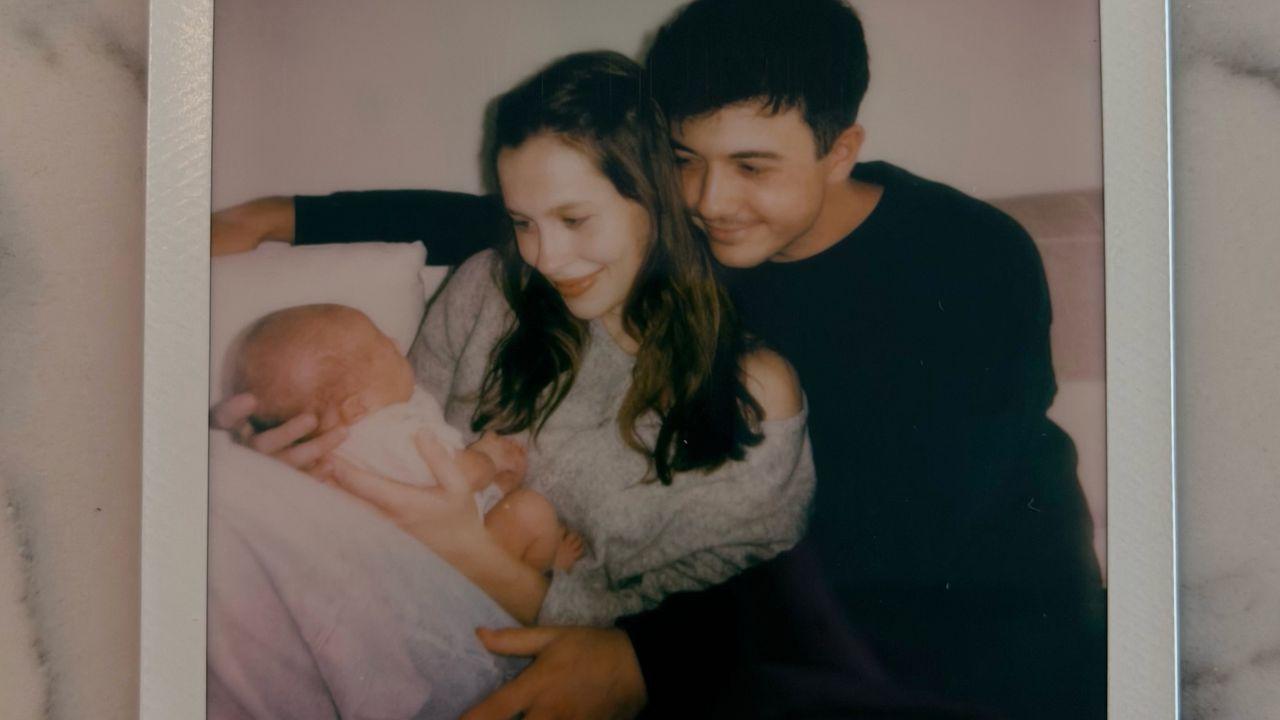 Image of Bradley Steven Perry, Natasha Bure, and their baby.