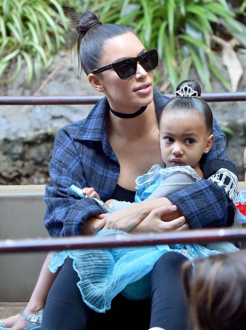 Kim Kardashian carries her little princess North on the Jungle Cruise at Disneyland