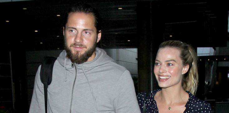 Margot Robbie and Tom Ackerley are a cute couple holding hands arriving at LAX Airport