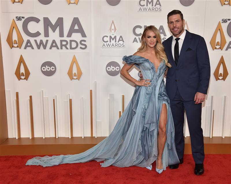 Carrie Underwood is joined by husband Mike Fisher on the red carpet at the  CMA Awards, where she will be participating in three separate