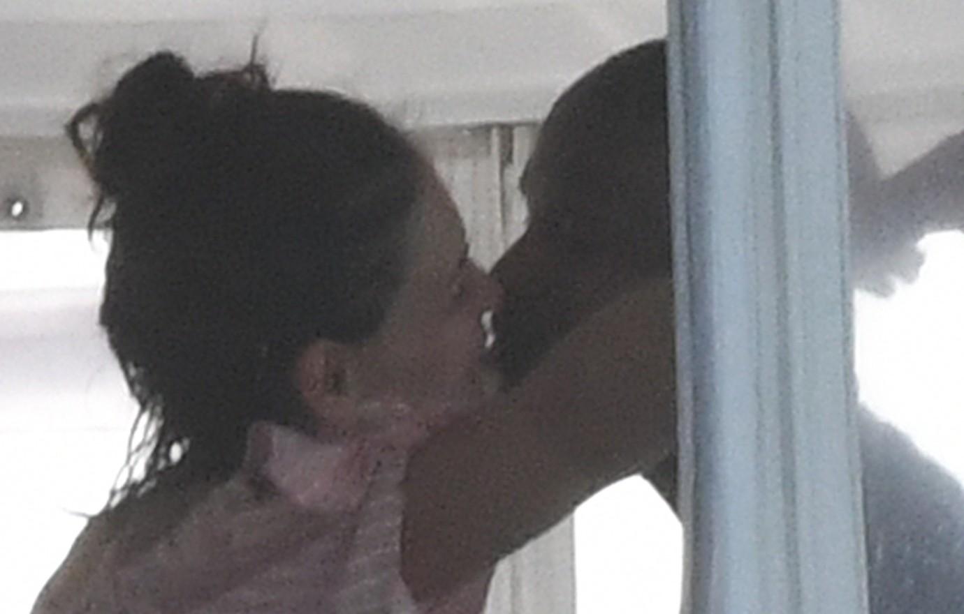 Katie Holmes and Jamie Foxx share an intimate kiss on a boat.