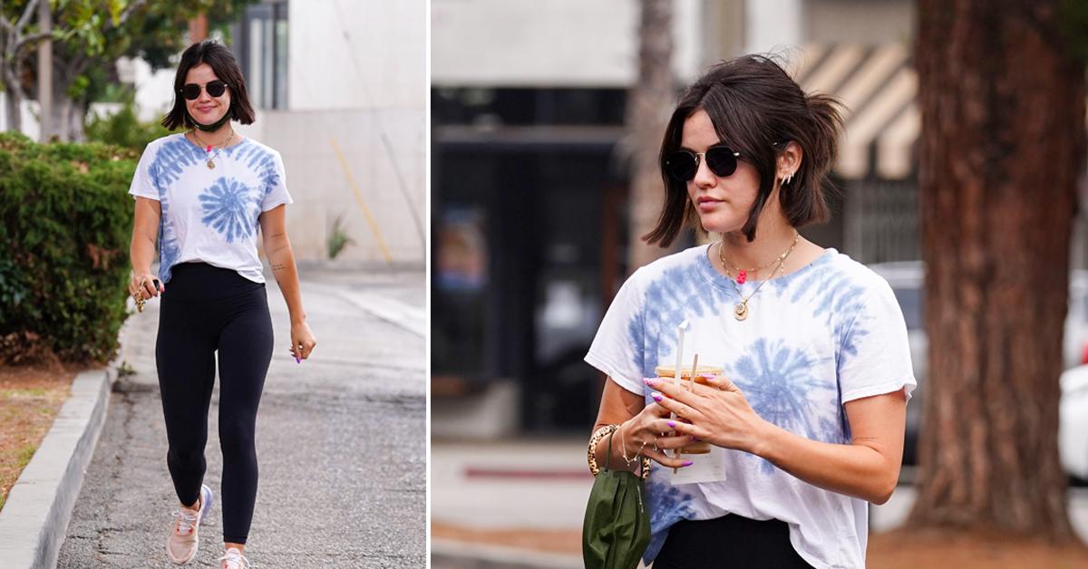 Lucy Hale wears a red 'LA' hat with denim jacket and black leggings during  a coffee