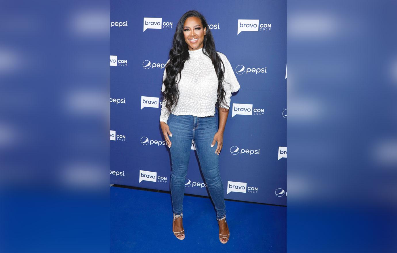 Kenya Moore Wearing White Top and Jeans