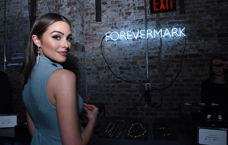 Olivia culpo trying on forevermark jewelry at the forevermark black label collection launch in nyc