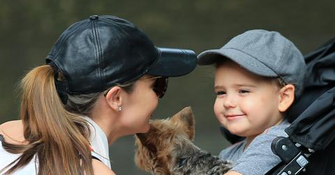 Flynn Bloom hugs and kisses his puppy Frankie while mom Miranda Kerr looks on tenderly in Central Park, NY