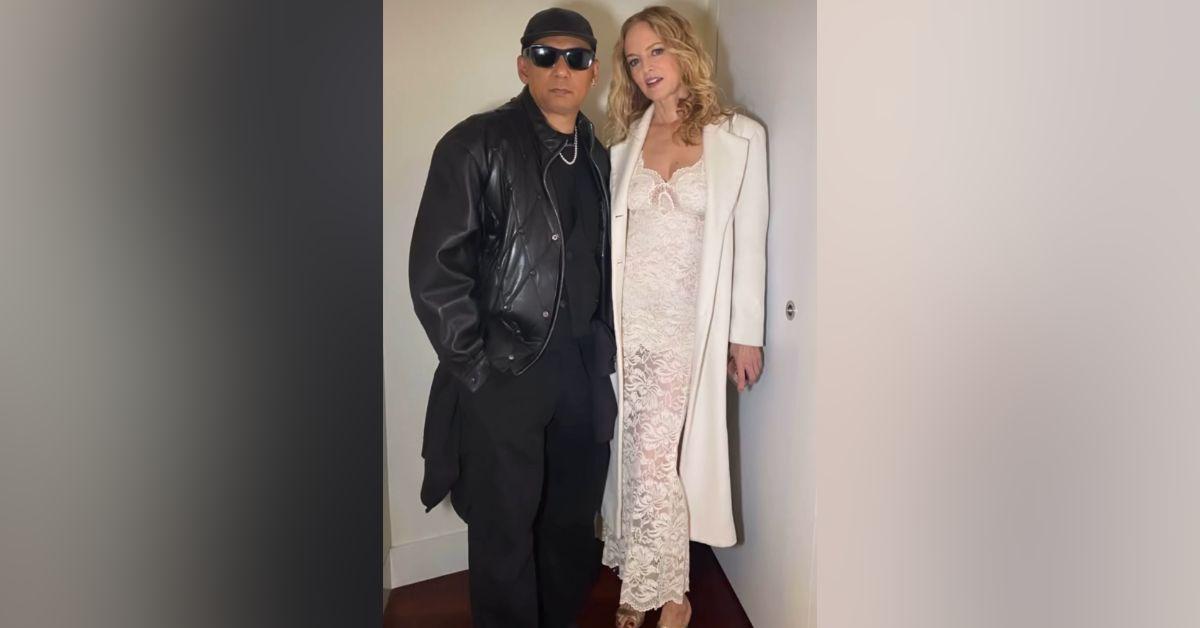 image of The actress paired her dress with a white coat and gold heels.