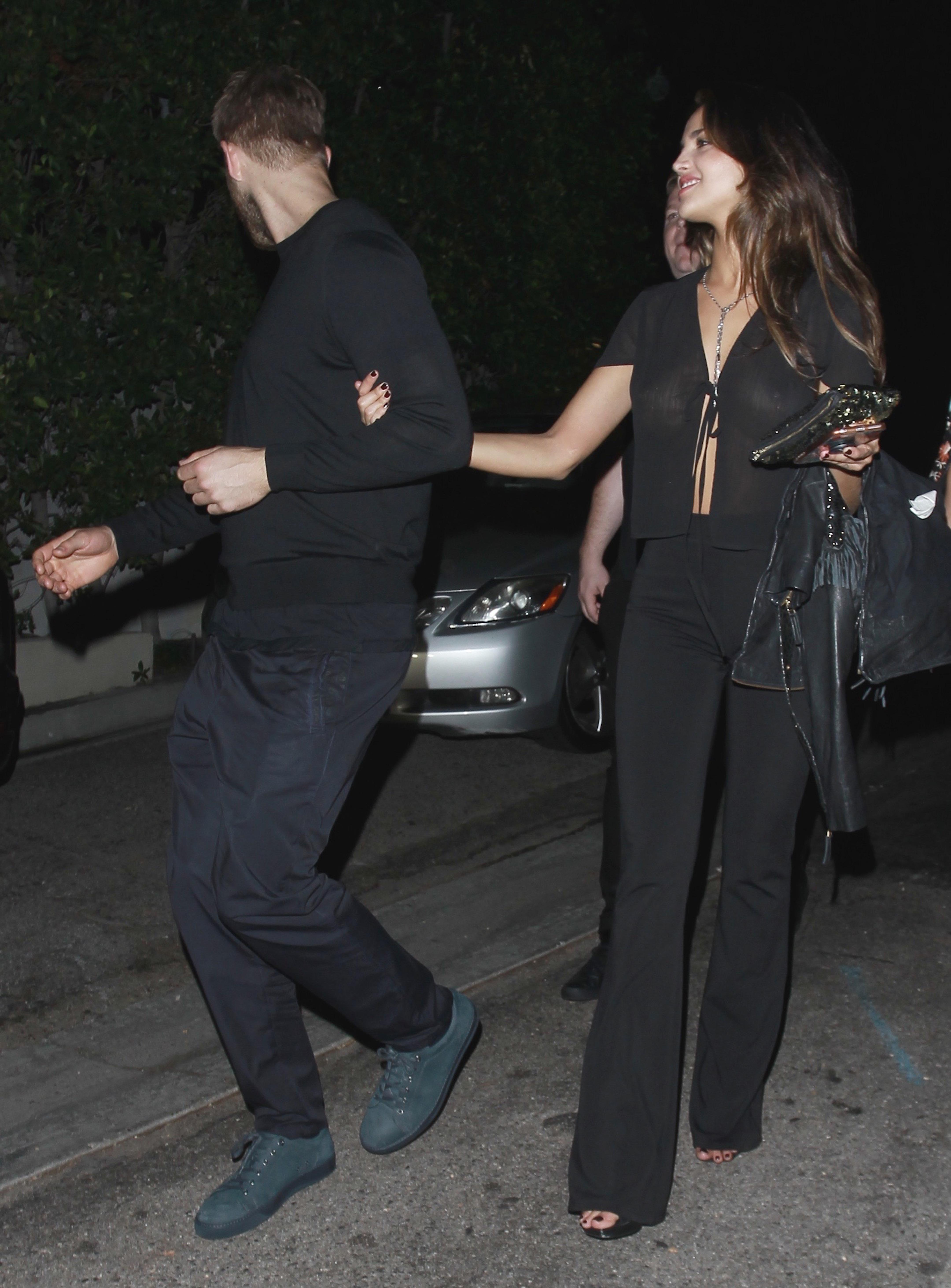 EXCLUSIVE: **PREMIUM EXCLUSIVE RATES APPLY** Calvin Harris is spotted in an arm in arm embrace with Eiza Gonzalez while leaving a party on Los Angeles.