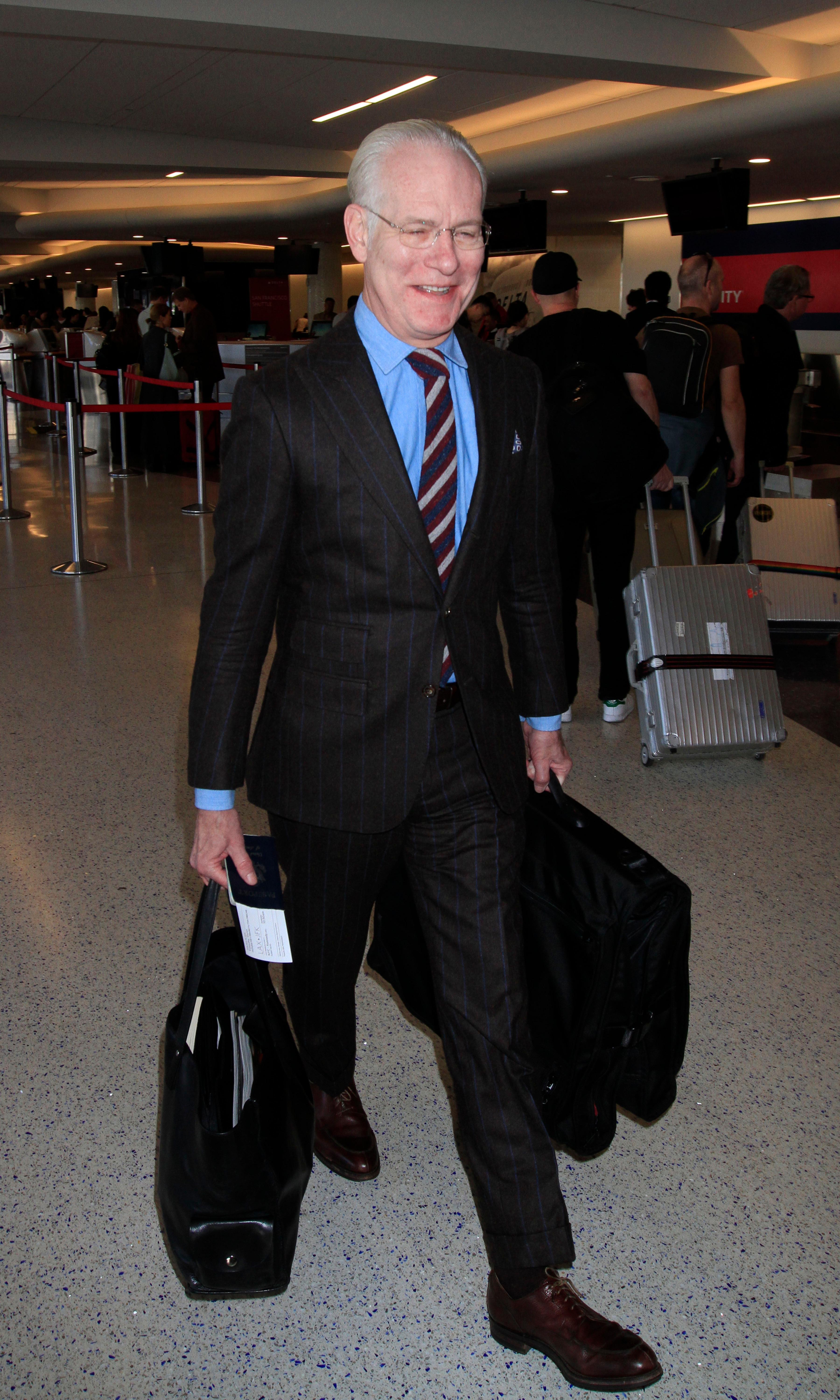 &#039;Project Runway&#039; star Tim Gunn looks dapper in a suit as he boards a flight out of Los Angeles