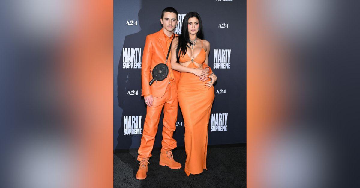 image of The couple wore matching bright orange outfits on the red carpet.