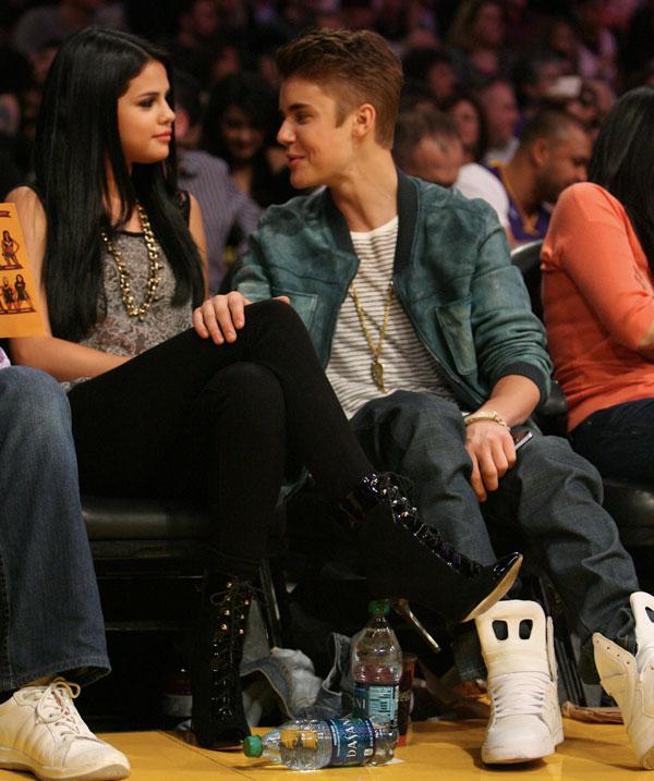 Justin Bieber and girlfriend Selena Gomez enjoy a kiss while sitting courtside at the Los Angeles Laker Vs San Antonio Spurs game in Los Angeles, Ca