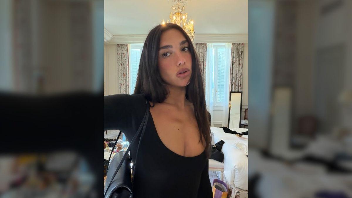 Photo of Dua Lipa rocked a black long-sleeve top in a casual daytime look.