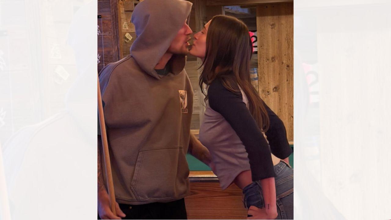 Image of Justin Bieber and Hailey Bieber posed inside of a sports bar.