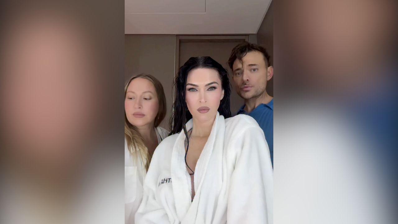 image of Megan Fox wore a dramatic black low-cut outfit in part of the video as she recreated the character’s confident attitude.