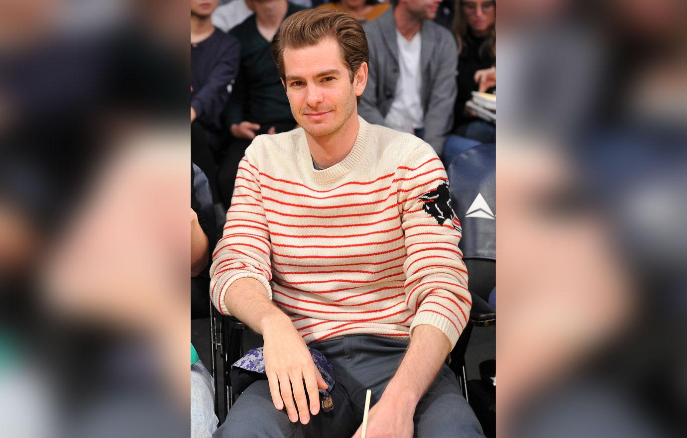 Andrew Garfield smiles while watching the Lakers vs the hawks.