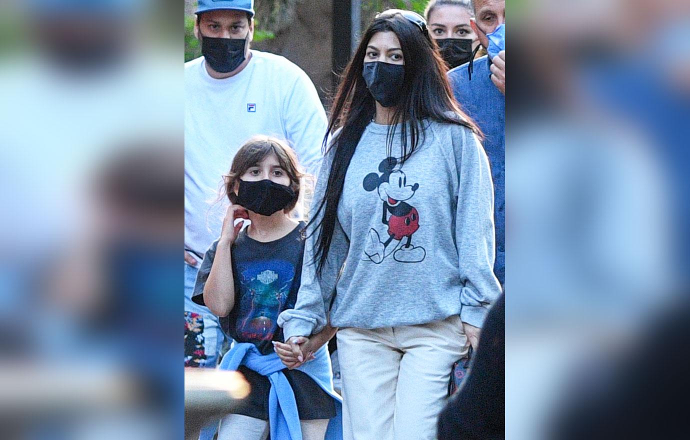 kourtney kardashian and travis barker take their modern family on a fun day out at disneyland