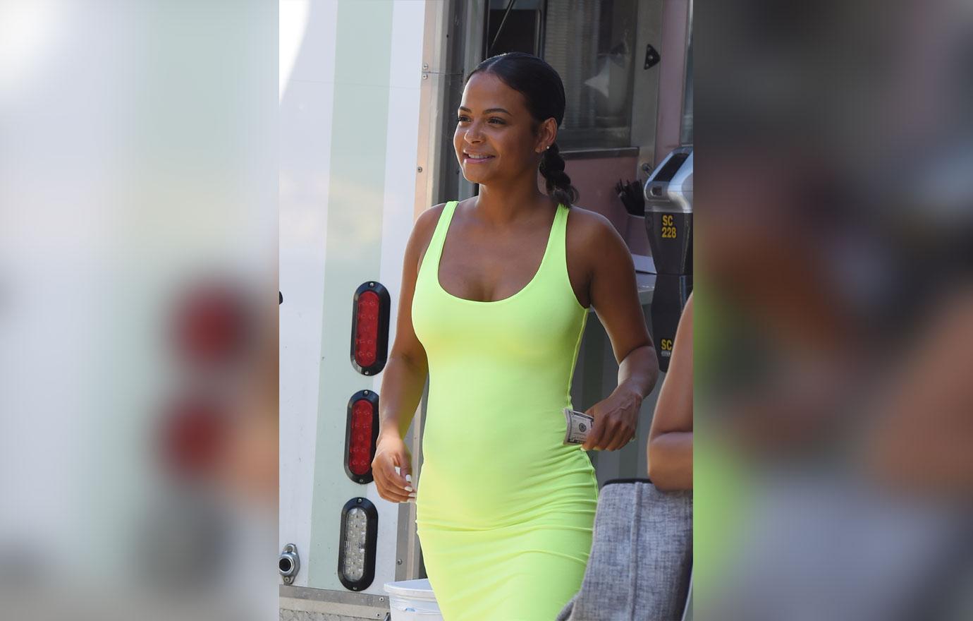 Christina Milian flashes a hint of her abs in neon yellow sports bra