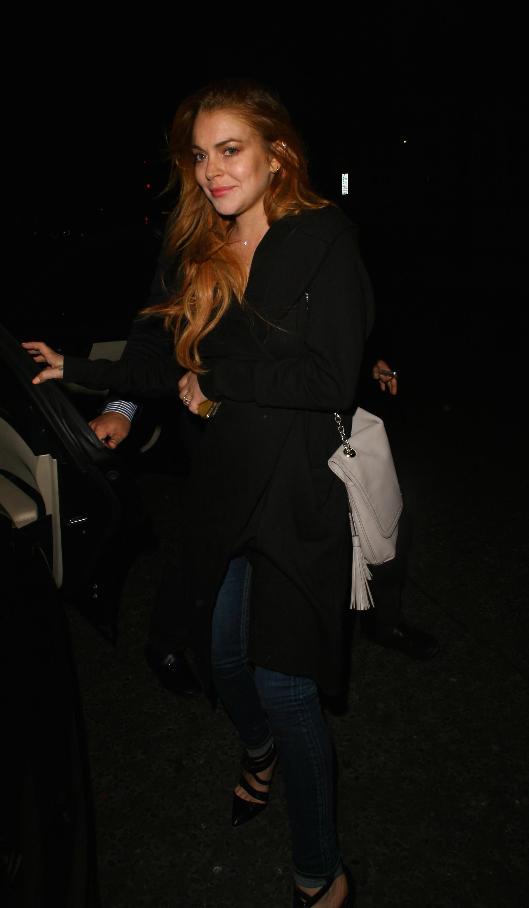 Lindsay Lohan is all smiles as she leaves the Corinthia Hotel in London, England at 1 am on September 25, 2014, after spending a few hours in there after her opening night of &#8216;Speed The Plow&#8217;