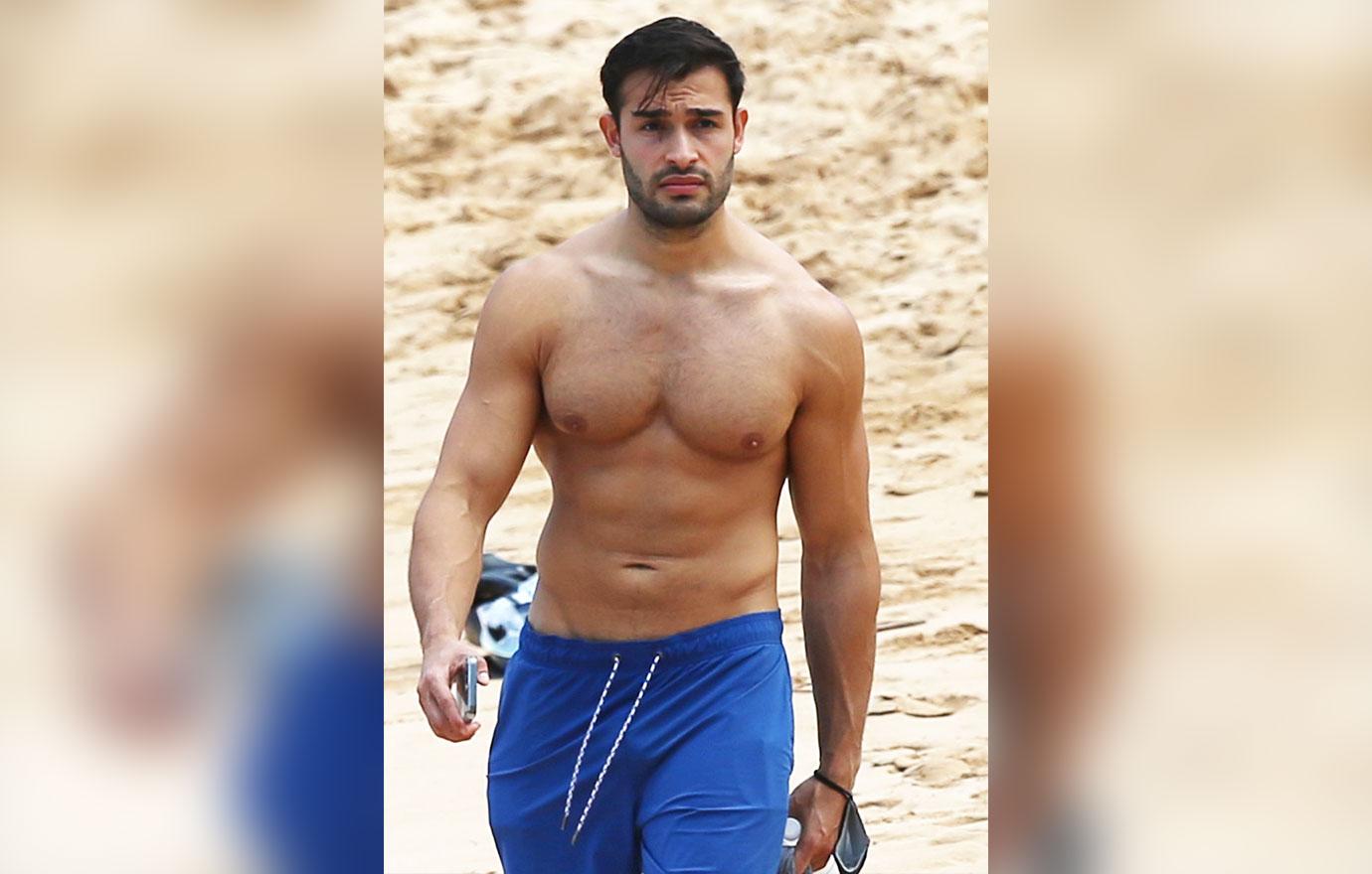 britney spears boyfriend sam asghari takes a solo stroll on the beach while on vacation in maui ok