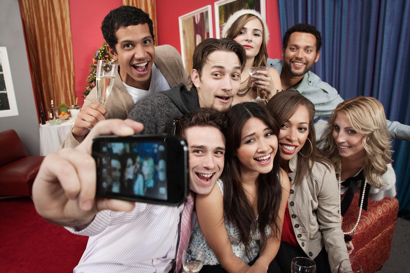 Friends taking group portrait at party