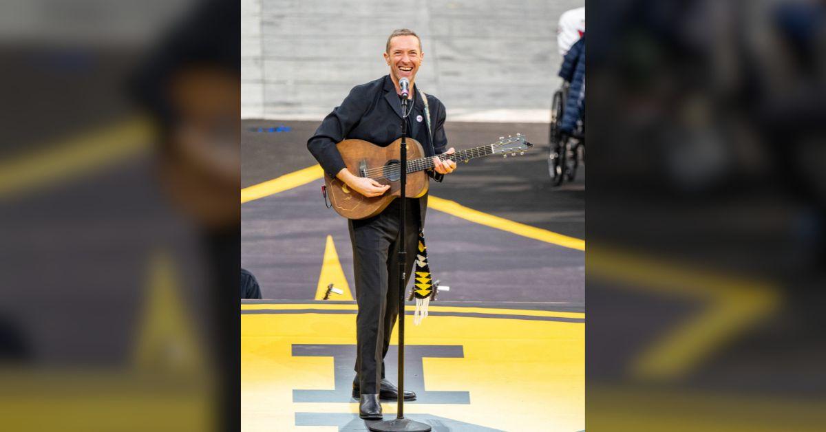 image of Chris Martin awkwardly addressed two fans in the crowd.