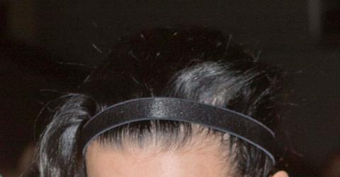 Katy Perry covers her face but shows off her colorful socks as she makes her way through LAX