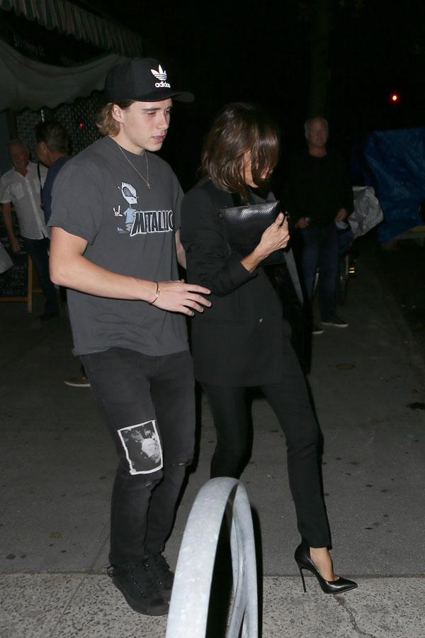 brooklyn beckham helping mom victoria beckham to car