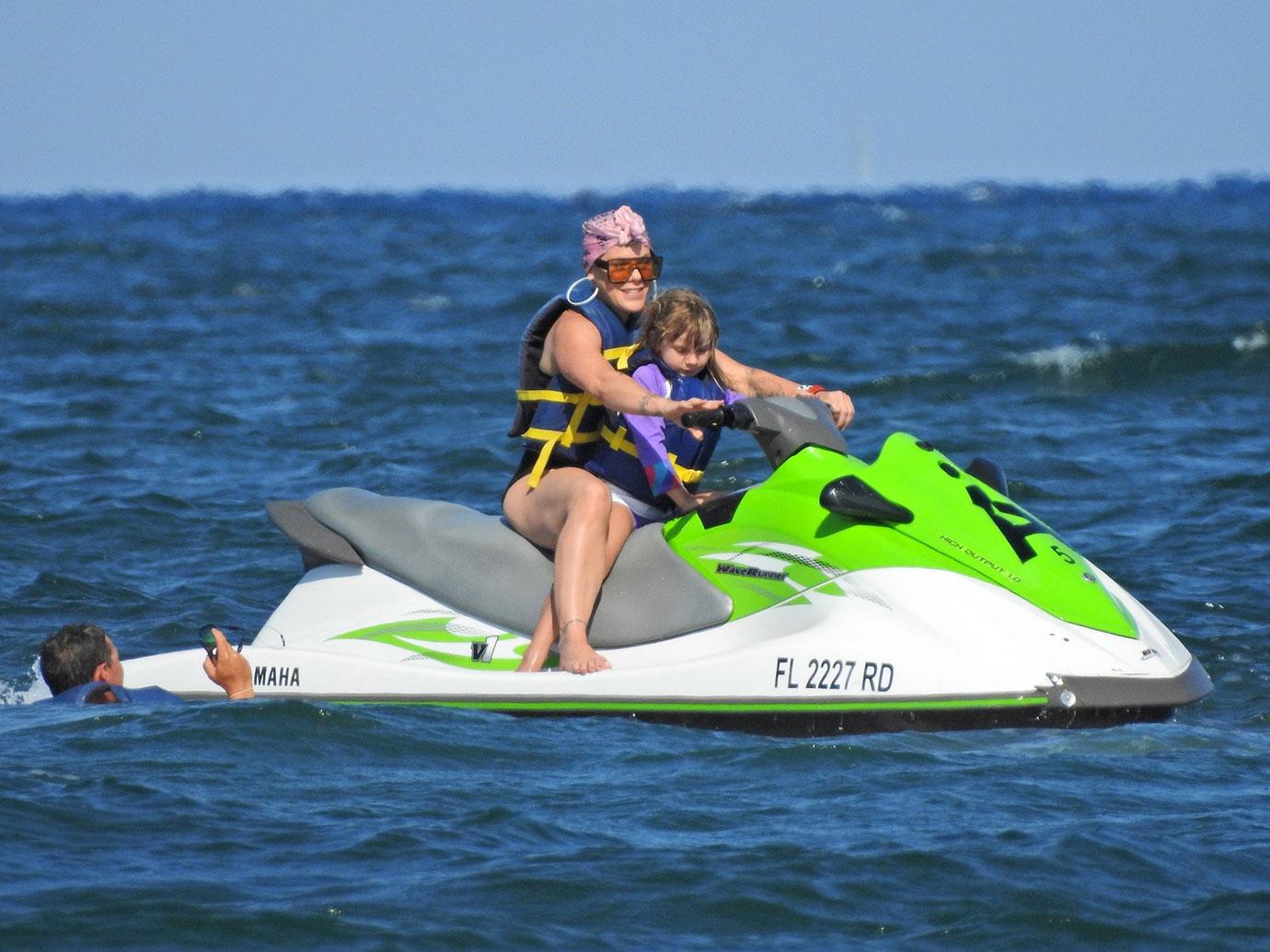 Pink and her adorable family ride some Jet Skis on the Beach in Florida